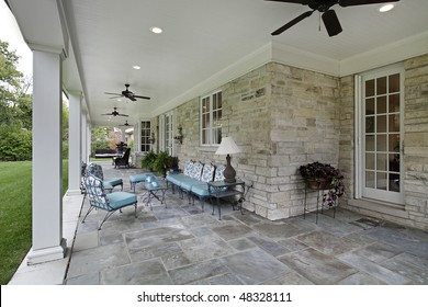 Blue Stone Patio With Columns And Blue Furniture