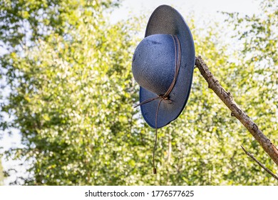 Blue Straw Hat On The Branch In The Woods. Lost And Found Concept, Missing Person. 