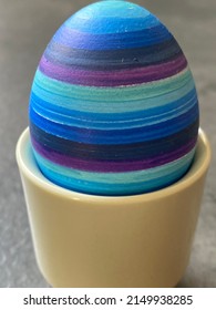 blue striped easter egg in eggcup