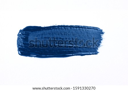 Blue stroke of the paint brush isolated on white. Classic blue color of year 2020
