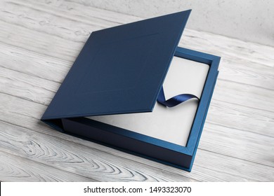 blue stylish square cardboard box for a photo album.
Bright original box for white wedding album.
leather family photo book in the open box
blue cardboard box for a photo book - Powered by Shutterstock