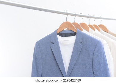 Blue Suit With Assorted White Dress Shirts Hanging On Hangers