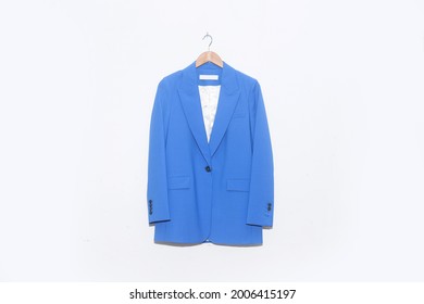 Blue Suit Jacket Hanging Isolated On A White Background.

