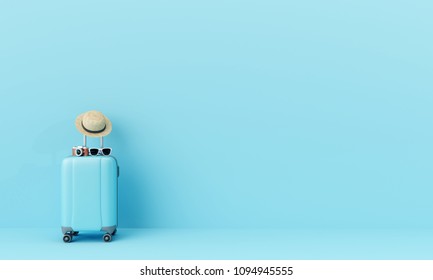 Blue suitcase with sun glasses, hat and camera on pastel blue background. travel concept. minimal style
					