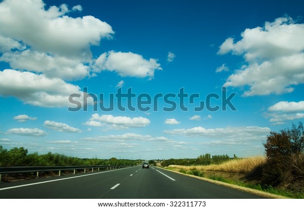 Blue sunny sky\
above highway - southern\
France