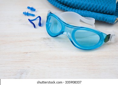 Blue Swimming Equipment On Wooden Background. Sport Concept