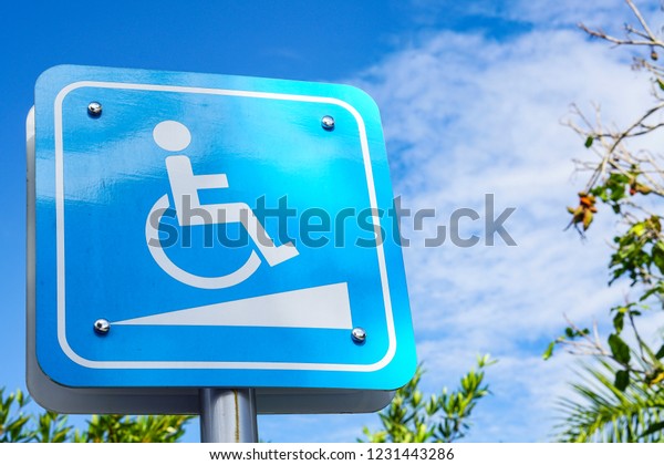 Blue symbols\
and disability symbols in the\
park.