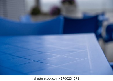 A blue table with geometric patterns in a relaxed outdoor setting.