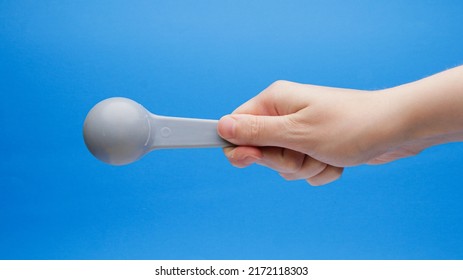 Blue Tablespoon Measuring Spoon Back Side In Hand