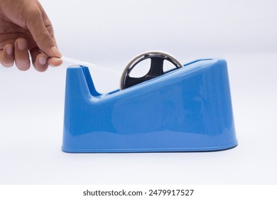 Blue Tape Dispenser with Serrated Cutting Wheel: This vibrant blue tape dispenser features a sleek design and a black, serrated cutting wheel. Ideal for office supplies, organization, or productivity - Powered by Shutterstock