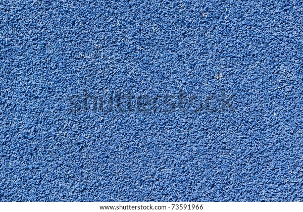 Blue tartan athletic\
running track texture on the stadium. Tartan track material is the\
trademarked all-weather synthetic track surfacing for athletics\
made of polyurethane