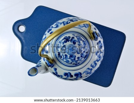 Blue teapot on blue coaster