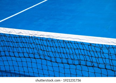 Blue Tennis Court With Net. Empty Sport Field Photo. Hard Court For Lawn Tennis. Summer Sport Activity Game Outdoor. White Markup On Blue Court. Sunny Day On Tennis Court. Sport Field In Park