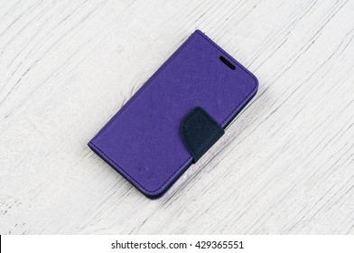 Blue Textile Wallet Case Cover For Mobile Phone On Vintage Wooden Background