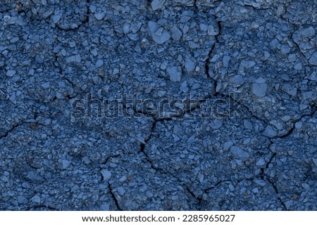 Blue texture for natural background. Dry rock covered with small cracks as a concept of erosion. Cracked stone texture or cracked ground pattern on top surface view. 