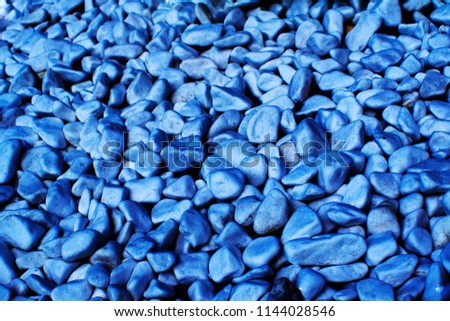 blue texture of the pebbles, colored background stones. Pile of stones, close-up of the blue pebbles, blue rocks for background or texture,