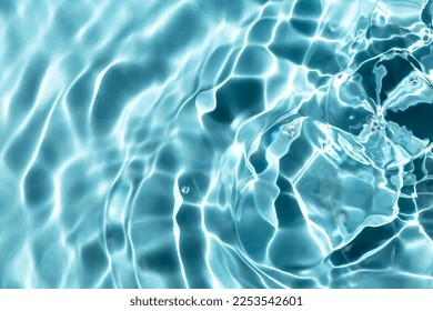 Blue textured background of waves with ripples on the water. Close-up, selective focus, defocus - Powered by Shutterstock
