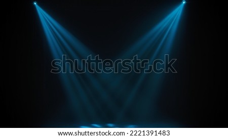 Blue theatrical beams of overhead light illuminating an empty dark stage. Bright neon spotlights and smoke on a black studio background. Light show, disco club lights.