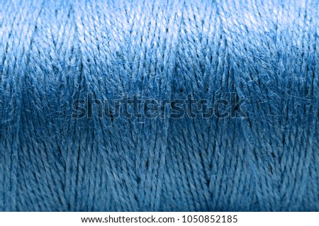 A blue threaded coil texture or background. Close up. Low deph of field.