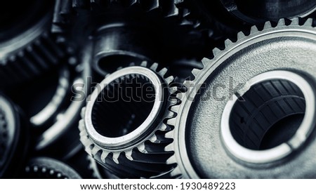Blue tint black industrial gears and cogs on black background, banner