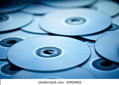 blue tinted close-up of a stack of cd-roms