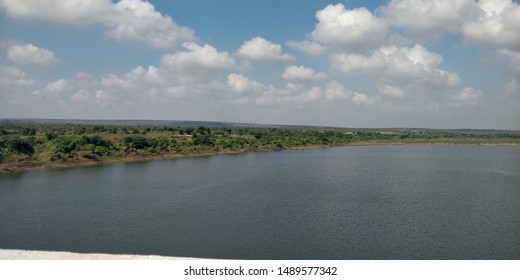 A blue tinted cloud and river cutting down the land