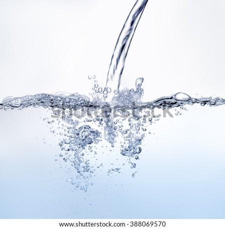 Blue tone water splashing against white background.
