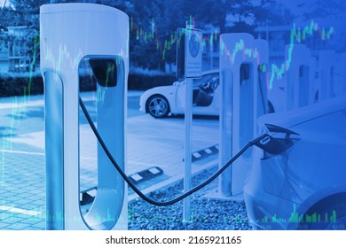 Blue Toned Photo Of Passenger Electric Car Replenishes Battery At Charging Station, Alternative Energy Development Concept, Electric Vehicle Production, Electric Energy Storage