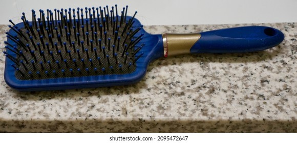 Blue Toothbrush On A Bathroom Counter