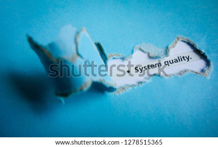 Blue torn paper with text system quality