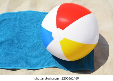 Blue Towel And Colorful Beach Ball On Sand