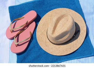 Blue Towel, Flip Flops And Straw Hat On Blanket, Above View