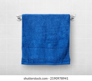 A blue towel hangs on a hanger rod. - Powered by Shutterstock