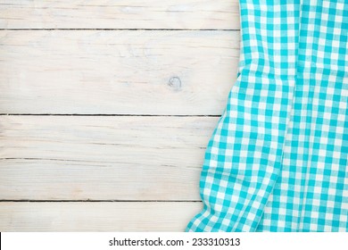 Blue Towel Over Wooden Kitchen Table. View From Above With Copy Space