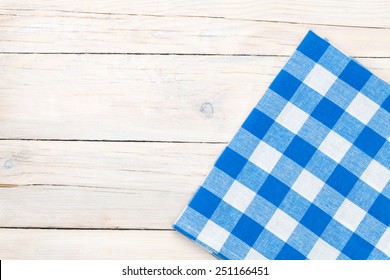 Blue Towel Over Wooden Kitchen Table. View From Above With Copy Space 