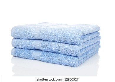 A Blue Towels Stacked Reflected On White Background