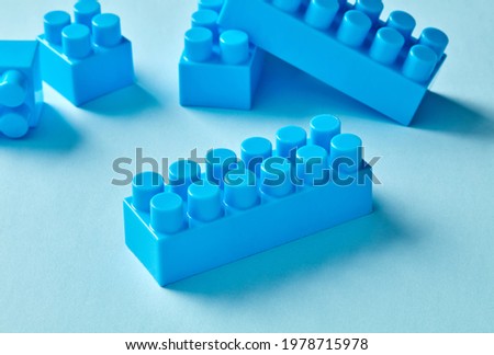 Blue toy bricks on blue background