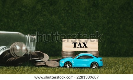 blue toy car picture  Stack of coins and wooden blocks with the concept of taxes, tax payments, government, data analytics, documents, financial research, reports, tax returns, calculations.