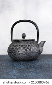 Blue traditional Asian iron teapot. Vertical orientation.