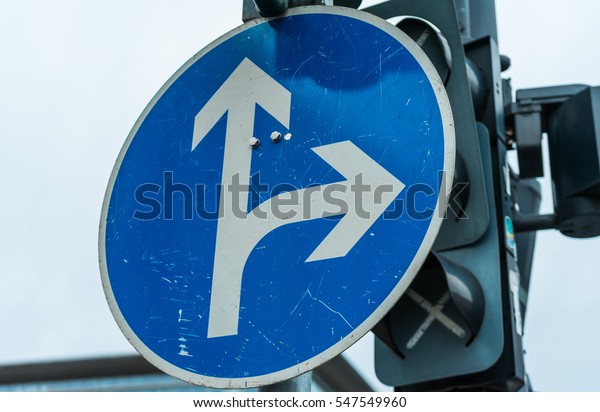 Blue\
traffic intersection direction sign with two\
arrows