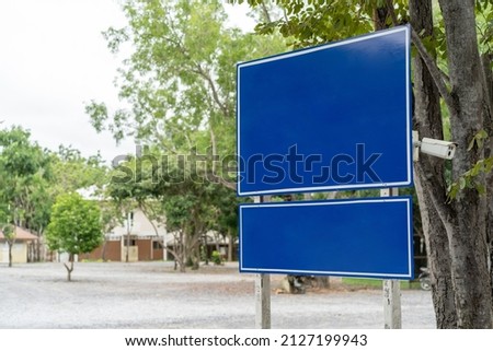 Blue traffic sign in paking lots with tree around. Clipping Paths