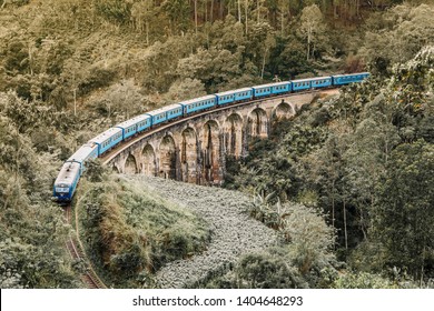 Blue train goes through jungle. Nine arch bridge, Demodara, Sri Lanka. Old bridge in Ceylon. Nine Arches Bridge from above, Sri Lanka.