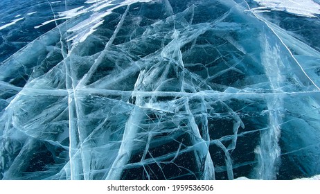 Blue transparent clear smooth ice with deep cracks. Beautiful amazing unique pattern of frozen Lake Baikal. View from above. Natural landmark of Russia. - Powered by Shutterstock