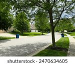 Blue trash cans line the street on trash day in an Indiana Neighborhood with copy space.