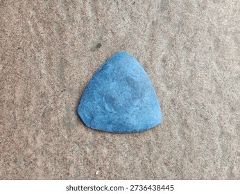 Blue triangular tailor's chalk on stone surface, professional sewing marking tool, Classic Blue Triangle Tailors Chalk, garment construction accessory, fabric pattern marking equipment, photo object, design material, graphic resource, raw picture, editable image, cut out, removable background 