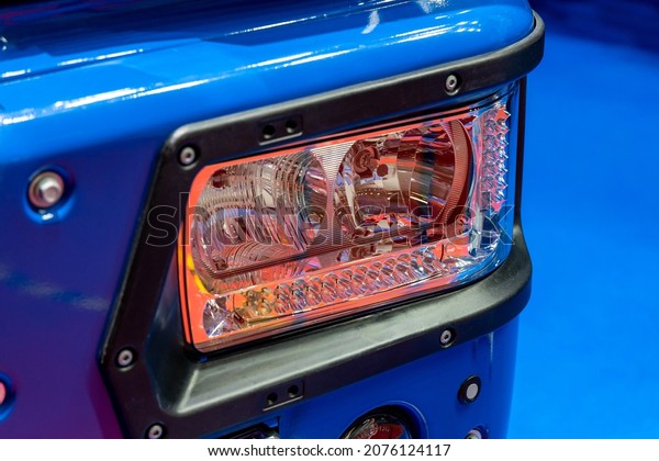 Blue truck headlight. Detail of a\
lorry close up. Truck electrical equipment. Road\
safety