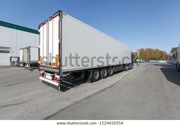 blue truck with white\
trailer