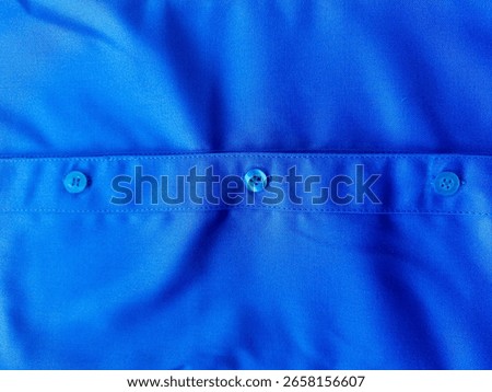 blue tshirt with button for background close up.  Close up of front and back views of blue shirts or business clothes on wooden hangers, People concept, Set of fashion and accessories. Mockup templat