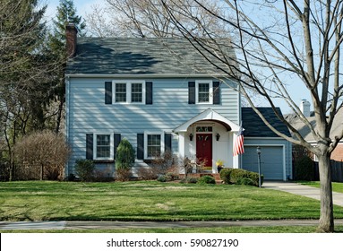 Blue Two Story House With American Flag