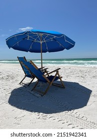 Blue Umbrella And Beach Chairs On Destin, Florida White Sand Beach